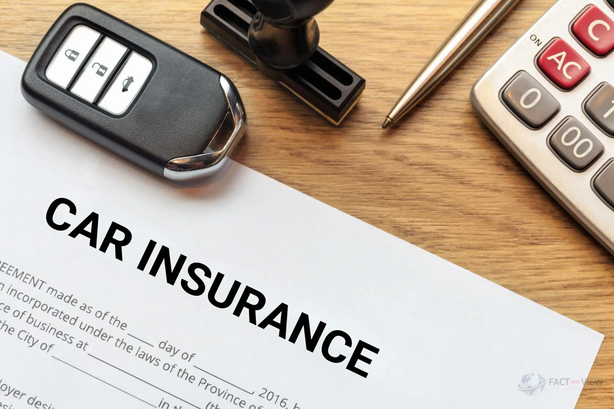 A car key resting on an auto insurance policy document, explaining why car insurance is so expensive.